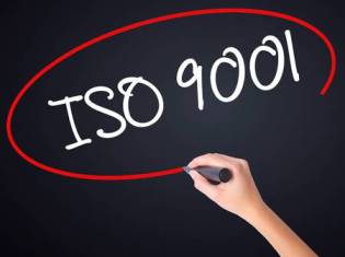 63829494-woman-hand-writing-iso-9001-on-blank-transparent-board-with-a-marker-isolated-over-black-background-